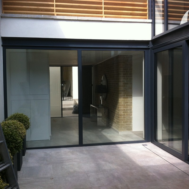 Floor-to-ceiling sliding doors opening to courtyard in Hemel Hempstead